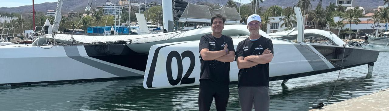 Claudio Cardoso e Sergio Avellar diante do trimarã Orion